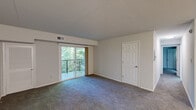 Located at 15 Fox Hall in Newark, Delaware, this two-bedroom, two-bathroom residence offers a well-organized single-floor layout with a thoughtful mix of comfort and functionality. The open living area features plush carpeting and flows seamlessly toward a private balcony accessed through sliding glass doors, offering pleasant views of the surrounding greenery. Adjacent to the living area, the kitchen is outfitted with white cabinetry, dark countertops, a classic subway tile backsplash, and a full suite of stainless steel appliances including a refrigerator, electric range, and dishwasher. The primary bedroom is generously proportioned, carpeted, and filled with natural light via the balcony access, while the second bedroom features carpeting and a bright window. Three closets throughout the unit provide ample storage. Both bathrooms are clean and functional, each featuring a tub-shower combination with white tile surrounds and wood-look vinyl flooring. A dedicated utility room and hallway round out the floor plan. The unit also includes multiple closets for added storage convenience, making this a practical and comfortable residence.