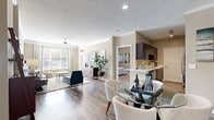 Located at 1200 Reserve Dr NE in Brookhaven, GA, this well-appointed 3-bedroom, 3-bathroom residence offers a thoughtfully designed single-level layout. The open-concept living and dining area is anchored by rich hardwood-style flooring, crown molding, and a ceiling fan, with large windows that flood the space with natural light. A glass-top dining table and comfortable seating area flow seamlessly into the kitchen, which features dark espresso cabinetry, stainless steel appliances, and a light quartz peninsula countertop ideal for casual dining or meal prep. Each of the three bedrooms is carpeted for comfort, with ceiling fans and windows that bring in natural light. The primary bedroom includes a walk-in closet with wire shelving for organized storage. All three bathrooms are consistently styled with dark vanity cabinetry, quartz countertops, large framed mirrors, and tub-shower combinations with tile surrounds. Wood-look flooring in the bathrooms adds a cohesive, modern touch throughout. A dedicated laundry room with a full-size washer and dryer adds everyday convenience. The warm, neutral color palette and consistent finishes throughout create a cohesive and inviting ambiance suited to comfortable living in the heart of Brookhaven.