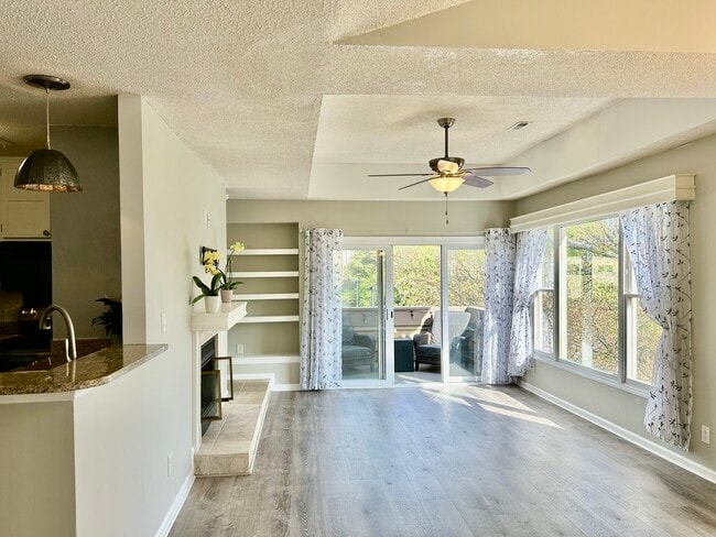 Living room with adjacent dining room and overlooking kitchen - 1101 E Morehead St