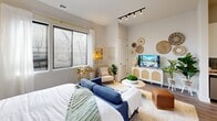 Located at 340 S Market St in downtown Wilmington, Delaware, this one-bedroom, one-bathroom unit offers a thoughtfully designed layout that maximizes its compact footprint. The open-concept living area flows seamlessly from the kitchen toward the main living space, creating an efficient and cohesive interior. Wood-look flooring runs throughout, providing visual continuity across all rooms.

The kitchen is a functional highlight, featuring two-tone cabinetry with white upper cabinets and gray lower cabinets, a gray tile backsplash, white quartz countertops, a matte black undermount sink with a matching faucet, and a full suite of stainless steel appliances including a refrigerator, electric range, built-in microwave, and dishwasher. Track lighting overhead adds a modern industrial touch.

The generously sized primary bedroom accommodates a seating area and features a decorative accent wall with patterned wallpaper, a walk-in closet, and a large window that allows natural light to filter in.

The bathroom offers a clean, modern aesthetic with a wood-toned vanity, white countertop, matte black hardware, and wood-look tile flooring. The neutral palette throughout the unit contributes to a bright and welcoming ambiance.