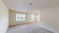 Located at 801 Cooper St in Deptford, NJ, this single-floor, one-bedroom, one-bathroom residence offers a practical and well-organized layout. The combined living and dining area is bright and open, featuring warm neutral-toned walls, plush carpeting, and multiple windows that invite abundant natural light and views of surrounding greenery. A pendant chandelier anchors the dining space, adding a subtle decorative touch.

The kitchen is efficiently designed with white raised-panel cabinetry, wood-look flooring, a full suite of appliances including a refrigerator, electric range, and dishwasher, along with ample counter space and a stainless steel sink. A pantry provides additional storage convenience.

The generously sized bedroom accommodates comfortable living with soft carpeting, a large window framing outdoor views, and a sliding-door closet. Two additional closets throughout the unit offer excellent storage capacity.

The bathroom features wood-look vinyl flooring, a white vanity with storage, and a full tub/shower combination with chrome grab bars. Completing the unit are a dedicated laundry room and a utility room, enhancing everyday functionality. The hallway connects all spaces with an efficient flow throughout this well-appointed home.