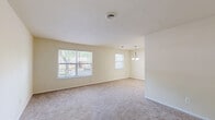 Located at 801 Cooper St in Deptford, NJ, this single-floor, one-bedroom, one-bathroom residence offers a practical and well-organized layout. The combined living and dining area is bright and open, featuring warm neutral-toned walls, plush carpeting, and multiple windows that invite abundant natural light and views of surrounding greenery. A pendant chandelier anchors the dining space, adding a subtle decorative touch.

The kitchen is efficiently designed with white raised-panel cabinetry, wood-look flooring, a full suite of appliances including a refrigerator, electric range, and dishwasher, along with ample counter space and a stainless steel sink. A pantry provides additional storage convenience.

The generously sized bedroom accommodates comfortable living with soft carpeting, a large window framing outdoor views, and a sliding-door closet. Two additional closets throughout the unit offer excellent storage capacity.

The bathroom features wood-look vinyl flooring, a white vanity with storage, and a full tub/shower combination with chrome grab bars. Completing the unit are a dedicated laundry room and a utility room, enhancing everyday functionality. The hallway connects all spaces with an efficient flow throughout this well-appointed home.