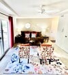 This charming single-story home offers a thoughtful layout within its 780 square feet. The living room boasts a ceiling fan, plush seating, and vibrant decor, creating an inviting atmosphere. The kitchen features honey-colored cabinets and granite countertops, while the dining area accommodates a round table perfect for intimate meals. Both bedrooms are well-appointed, with the primary bedroom spanning 170 square feet and featuring ample closet space. The bathroom showcases a tub-shower combo and wooden flooring. Throughout the home, natural light floods in through large windows adorned with both blinds and curtains, enhancing the overall warmth and appeal of this cozy residence.