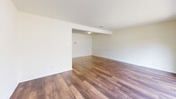 Located at 3481 S Hills Ave in Fort Worth, TX, this two-story home offers a well-organized layout across two floors. The main level features a spacious living area with rich, dark hardwood-style flooring and a sliding glass door that opens to a private balcony with outdoor views — filling the space with natural light. The galley-style kitchen is outfitted with white cabinetry, laminate countertops, a double sink, and white appliances, with hardwood-style flooring continuing throughout. Upstairs, both bedrooms are carpeted and equipped with ceiling fans. The generously sized primary bedroom includes ample closet storage, with an open shelving closet and a walk-in closet. The second bedroom also features carpet, a ceiling fan, and a nearby window for natural light. Three bathrooms serve the home, each featuring speckled stone-look countertops, large framed mirrors, and clean white finishes. The bathrooms include a tub-shower combination with white tile surround. Multiple staircases connect the levels, complemented by a hallway and three closets throughout for convenient storage. Textured ceilings are featured across various rooms, adding subtle architectural character to this functional and well-laid-out home.