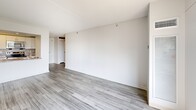 Located at 97 Rockwell Ave in Medford, MA, this one-bedroom, one-bathroom unit offers a clean, modern aesthetic throughout its efficiently designed single-floor layout. The open-concept living and kitchen area is bathed in natural light, courtesy of large sliding windows that frame views of the surrounding neighborhood and greenery. Light wood-style flooring runs throughout the space, lending a bright and cohesive feel to every room.

The kitchen is well-appointed with white cabinetry, granite-style countertops, and a full suite of stainless steel appliances, including a refrigerator, electric range, over-the-range microwave, and dishwasher. A galley-style layout maximizes functionality within the space.

The bedroom is generously sized, offering ample room for furnishings, and features the same light flooring and crisp white walls found throughout the unit. A closet provides convenient storage.

The bathroom is clean and straightforward, featuring a full soaking tub with shower, white tile surround, and wood-look tile flooring that ties into the overall design palette. The unit's bright, neutral color scheme and updated finishes create a comfortable, move-in-ready living environment.