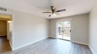 Located at 516 S Carroll Blvd in Denton, TX, this 2-bedroom, 2-bathroom unit offers a well-designed single-floor layout with consistent, modern finishes throughout. Light-toned hardwood-style flooring flows through the living areas and bedrooms, complementing the neutral wall palette and clean white trim.

The living room is bright and open, featuring a ceiling fan with light fixture and a sliding glass door that opens to a private balcony, allowing for natural light and outdoor views. The galley-style kitchen is efficiently designed with white cabinetry, dark countertops, a stainless steel sink, and white appliances including an electric range and refrigerator.

Both bedrooms are well-proportioned and include ceiling fans. The primary bedroom offers a comfortable footprint, while the second bedroom features a window with natural light and direct access to the hallway. A dedicated closet provides additional storage.

The two bathrooms continue the clean aesthetic with white cabinetry, dark countertop vanities, and a full tub-shower combination. Over-toilet storage cabinets add practical functionality. A hallway connects the main living areas with the bedrooms and bathrooms, creating a logical and efficient flow throughout the unit.