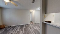 Located in Burleson, TX, this 2-bedroom, 2-bathroom unit offers a practical and comfortable single-floor layout. The combined kitchen and living area features durable wood-style plank flooring throughout, creating a cohesive and easy-to-maintain space. The kitchen is equipped with white cabinetry, a built-in sink, stainless steel appliances including a refrigerator and dishwasher, and a textured ceiling with recessed lighting. The living area flows naturally from the kitchen and is brightened by natural light. The primary bedroom is a well-proportioned retreat featuring wood-style flooring, two large windows with blinds that invite natural light and outdoor views, a ceiling fan with light fixture, a textured ceiling, and a spacious sliding-door closet. The second bedroom is carpeted and offers a quiet, cozy atmosphere. A dedicated walk-in closet with dual shelving and hanging rods provides ample storage. Both bathrooms feature clean white tub/shower combos, built-in shelving, and wood-style flooring, maintaining a consistent aesthetic throughout. The neutral color palette and practical finishes make this a versatile and move-in ready space.