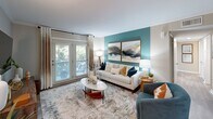 Located at 1505 Greenbrier Ridge Way in Knoxville, TN, this single-floor, 3-bedroom, 3-bathroom home offers a well-designed layout that maximizes every square foot. The living room serves as the centerpiece of the home, featuring a bold teal accent wall, crown molding, and French doors that flood the space with natural light while providing a view of the outdoors. Adjacent to the living room, the dining area features wood-look flooring, a chair rail detail, and a bright, open connection to the kitchen. The kitchen is equipped with white shaker cabinetry, granite countertops, and stainless steel appliances, with a seamless sightline into the dining space. Each of the three bedrooms carries a cohesive design aesthetic, highlighted by teal accent walls, plush carpeting, ceiling fans, and windows that bring in natural light. The primary bedroom offers a comfortable, well-proportioned retreat. The three bathrooms are finished with granite-topped vanities, white cabinetry, and wood-look tile flooring. A dedicated laundry area includes a stacked washer and dryer unit alongside built-in shelving for additional storage. The hallway connects all spaces efficiently, giving the home a practical yet polished flow throughout.