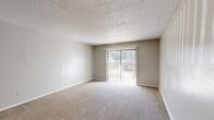 Located at 2845 Zelda Rd in Montgomery, Alabama, this single-floor residence offers two bedrooms, two bathrooms, and a practical, well-organized layout. The living room is a welcoming, open space featuring neutral-toned carpet and a sliding glass door with vertical blinds that invites natural light and provides outdoor access. Adjacent to the living area, a dedicated dining room offers a defined space for meals. The kitchen is equipped with white cabinetry, light stone-look countertops, wood-look flooring, a dishwasher, and an electric range, providing a functional and clean cooking environment. The generously sized primary bedroom includes a large double-door closet and direct access to one of the two bathrooms. The second bedroom is well-proportioned, also carpeted, and features a window that brings in natural light. Both bathrooms are finished with white vanities, stone-look countertops, large mirrors, and tub/shower combinations. Throughout the home, textured ceilings and neutral wall tones create a consistent, understated aesthetic. Additional highlights include four closets for ample storage, a dedicated laundry area, a utility room, and a central hallway connecting all rooms efficiently.