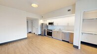 Located at 224 23rd St in the heart of Miami Beach, FL, this efficiently designed studio offers a clean, contemporary aesthetic across a single thoughtfully arranged floor. Light-toned wood-look flooring runs throughout, complementing the bright white walls and creating a cohesive, airy feel.

The open-concept living area flows seamlessly from the entry hallway, drawing the eye toward a full-width glass door that opens to a private balcony, framing views of the surrounding Miami Beach neighborhood and allowing abundant natural light to fill the space.

The kitchen is well-appointed and positioned along one wall, featuring a full suite of stainless steel appliances including a refrigerator, range with oven, built-in microwave, and dishwasher. Two-tone cabinetry pairs warm wood lower cabinets with crisp white upper cabinets accented by under-cabinet LED lighting, adding both functionality and a modern design touch. A clean white countertop with an integrated sink completes the setup.

The bathroom is finished with classic white subway tile surrounding a full soaking tub and shower combination, complemented by light flooring and minimalist fixtures for a clean, timeless look.

The hallway connects the main living area to the bathroom, providing a practical transition through the space. Overall, the unit presents a modern, move-in-ready environment ideal for Miami Beach living.