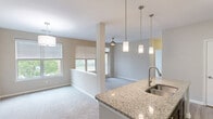 This thoughtfully designed 1-bedroom, 1-bathroom residence in Columbia, SC offers a comfortable and functional single-floor layout. The open-concept living and dining area flows seamlessly from the kitchen, creating a bright, connected space bathed in natural light from multiple windows with views of lush greenery. Plush carpeting runs throughout the living and bedroom areas, adding warmth underfoot.

The kitchen is a standout feature, showcasing granite countertops, a center island with a stainless steel undermount sink, dark espresso cabinetry reaching to the ceiling, a mosaic tile backsplash, and a full suite of stainless steel appliances including a refrigerator, range, and built-in microwave. Elegant pendant lighting illuminates the island and living area.

The generously sized bedroom offers dual windows with peaceful outdoor views, plush carpet, a ceiling fan, and convenient access to both a closet and the bathroom. The full bathroom is finished with granite countertops, dark cabinetry, tile flooring, and a tub/shower combination. A dedicated closet provides additional storage. The neutral color palette and consistent finishes throughout create a cohesive, move-in-ready environment.