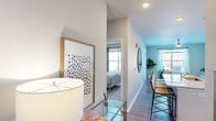 This thoughtfully designed one-bedroom, one-bathroom unit at 3492 Jefferson Ridge Dr in Jeffersonville, Indiana, offers a efficient and functional single-floor layout with modern finishes throughout. The welcoming entrance hall opens into a bright, open-concept living area bathed in natural light from large windows. The living room provides a comfortable gathering space, complete with a ceiling fan and wood-style flooring that flows seamlessly through the main areas.

The kitchen is a standout feature, showcasing white shaker cabinetry extending to the ceiling for ample storage, granite countertops, a kitchen island, and a full suite of stainless steel appliances including a refrigerator, range, and over-the-range microwave. The space is both stylish and highly functional.

The bedroom offers a tranquil retreat with plush carpeting, a generous window with outdoor views, and access to two closets for abundant storage. The full bathroom is finished with a granite-topped vanity, white shaker cabinetry, and wood-style flooring, maintaining the cohesive modern aesthetic found throughout the unit.

A dedicated laundry room with a full-size washer and dryer adds everyday convenience. The unit also includes two closets and a private entrance, rounding out a well-organized and comfortable living space.
