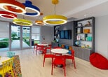 Located at 28250 S Dixie Hwy in Florida, this single-story amenity facility offers a thoughtfully designed collection of spaces catering to both recreation and fitness needs.

The children's play area is a visually dynamic room characterized by bold, colorful ring-shaped pendant lights in red, yellow, blue, and orange that hang from the ceiling, creating an energetic and engaging atmosphere. Light wood-look flooring runs throughout, and round white tables paired with vibrant red chairs provide ample space for activities. A built-in gray shelving unit along one wall houses a flat-screen television, books, toys, and educational materials, while a colorful area rug adds additional visual interest. Large glass doors along one wall allow natural light to pour in and offer views of an outdoor courtyard area.

The fitness center is divided into distinct zones. One area is dedicated to cardio equipment, including multiple treadmills, a stationary bike, and a stair climber, with windows providing outdoor views and natural light. A separate strength training area features a comprehensive selection of cable and resistance machines arranged across durable rubberized flooring. French doors lead directly outdoors, enhancing ventilation and connectivity to the surrounding grounds. The fitness center maintains a clean, functional aesthetic with white walls and recessed lighting throughout.