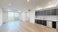 Located at 951 Ogden Ave in the heart of Los Angeles, this thoughtfully designed 1-bedroom, 1-bathroom residence offers a clean, contemporary aesthetic with modern finishes throughout. Light-toned hardwood flooring flows seamlessly across every room, lending a warm and cohesive feel to the entire unit.

The open-concept kitchen and living area serves as the heart of the home, featuring sleek dark cabinetry, light countertops, a tiled backsplash, and a full suite of stainless steel appliances including a refrigerator, gas cooktop, and built-in microwave. Recessed lighting illuminates the space, while sliding glass doors lead directly to a private balcony with open views — ideal for enjoying the Southern California climate.

The bedroom is generously proportioned, offering large mirrored closet doors that reflect natural light and enhance the sense of space. A wide window frames neighborhood views, adding brightness and an airy quality to the room.

The bathroom is finished in a clean, modern style with light-wood-look flooring, a dark vanity, and a full tub-shower combination enclosed by sliding glass doors. Additional conveniences include a dedicated in-unit laundry area and a utility room. Recessed lighting throughout the unit ensures a bright, polished atmosphere at every turn.