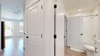 Located at 3014 Dr. Martin Luther King Jr. St. S in Saint Petersburg, FL, this thoughtfully designed one-bedroom, one-bathroom unit offers a clean, modern aesthetic across a single floor. Light wood-style flooring flows consistently throughout, complementing the bright white walls and creating a cohesive, airy atmosphere.

The open-concept living and kitchen area serves as the heart of the unit. The kitchen is well-appointed with white shaker cabinetry featuring sleek black hardware, granite-style countertops, and a full suite of stainless steel appliances including a refrigerator, electric range, over-the-range microwave, and dishwasher. A full-lite door in the kitchen allows natural light to pour in and provides outdoor access.

The living area is generously proportioned, featuring a ceiling fan with light fixture and a window with blinds that brings in additional natural light. The bedroom offers a comfortable, well-sized retreat with vaulted ceilings, neutral walls, and continued light flooring. A dedicated closet provides practical storage.

The bathroom features a granite-topped vanity with white cabinetry and black hardware, a tub/shower combination, and recessed lighting. The hallway connecting the rooms is lined with two-panel white interior doors accented by black hardware, adding a modern touch throughout the unit.