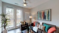 Located at 10300 University Pkwy in Pensacola, Florida, this single-floor residential unit offers a thoughtfully designed layout with a range of functional and attractive living spaces. The open living and dining area serves as the heart of the unit, featuring wood-style flooring, a ceiling fan, a wall-mounted fireplace, and large glass doors that open onto a private balcony overlooking lush, wooded surroundings. Natural light flows freely through the expansive glazing, creating a bright and welcoming atmosphere throughout.

The kitchen is outfitted with stainless steel appliances, including a range, microwave, and refrigerator, complemented by granite-style countertops, two-tone cabinetry in white and warm wood tones, and track lighting overhead.

The bedrooms are comfortably sized, each featuring ceiling fans, wood-style flooring, and windows that invite natural light. One bedroom includes a dedicated desk area, making it well-suited for study or remote work.

The bathrooms are clean and modern, each equipped with a tub-shower combination, granite-topped vanity with wood cabinetry, recessed lighting, and wood-style flooring. The overall aesthetic throughout the unit is contemporary and cohesive, with neutral wall tones providing a versatile backdrop for a variety of décor styles.