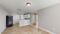 Located at 1101 Corbett Avenue North in Wilson, NC, this single-story 2-bedroom, 1-bathroom home offers a practical and well-designed layout. The open-concept main living area seamlessly connects the living room, dining area, and kitchen, creating a cohesive and functional space. The kitchen is a standout feature, boasting white cabinetry, granite-style countertops, a mosaic tile backsplash, a gas range, and a peninsula breakfast bar that adds both workspace and casual dining options. Natural light filters in through windows fitted with blinds, brightening the neutral gray walls and light wood-style vinyl flooring that runs consistently throughout the home. The primary bedroom is a comfortable size, featuring a closet and windows that bring in ample daylight. The second bedroom also includes natural light from dual windows, making it a bright and versatile space. Three closets throughout the home provide generous storage. The full bathroom includes a tub-shower combination with clean white surrounds. A dedicated laundry area with washer/dryer hookups adds everyday convenience. The home's clean, updated finishes and cohesive design make it a move-in ready option in Wilson, NC.