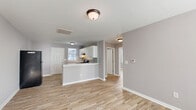 Located at 1101 Corbett Avenue North in Wilson, NC, this single-story 2-bedroom, 1-bathroom home offers a practical and well-designed layout. The open-concept main living area seamlessly connects the living room, dining area, and kitchen, creating a cohesive and functional space. The kitchen is a standout feature, boasting white cabinetry, granite-style countertops, a mosaic tile backsplash, a gas range, and a peninsula breakfast bar that adds both workspace and casual dining options. Natural light filters in through windows fitted with blinds, brightening the neutral gray walls and light wood-style vinyl flooring that runs consistently throughout the home. The primary bedroom is a comfortable size, featuring a closet and windows that bring in ample daylight. The second bedroom also includes natural light from dual windows, making it a bright and versatile space. Three closets throughout the home provide generous storage. The full bathroom includes a tub-shower combination with clean white surrounds. A dedicated laundry area with washer/dryer hookups adds everyday convenience. The home's clean, updated finishes and cohesive design make it a move-in ready option in Wilson, NC.