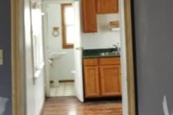 View of the kitchen and bath from living room - 1133 E Kane Pl