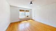 Located at 2665 Rivermont Ave in Lynchburg, Virginia, this 3-bedroom, 1-bathroom unit offers a practical and well-organized single-floor layout. Warm-toned hardwood floors run consistently throughout every room, lending a cohesive and classic character to the space. Crown molding accents the living areas, adding a touch of traditional architectural detail.

The living room provides a comfortable common area, while the kitchen features white cabinetry, a subway tile backsplash, butcher block countertops, and a window that brings in natural light and outdoor views. The layout connects rooms via a central hallway, making navigation straightforward.

Each of the three bedrooms is finished with the same hardwood flooring and crown molding found throughout the unit. The bedrooms receive natural light through windows fitted with blinds, and baseboard heating units are present in each room. Overhead light fixtures are installed in the bedrooms. The spacious primary bedroom offers ample room for furnishings.

The bathroom features classic penny tile flooring, a window for natural light and ventilation, a tiled shower, and a soaking tub, maintaining the unit's traditional aesthetic. Overall, the space presents a clean, functional design rooted in classic residential style.