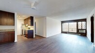 Located at 430 Mendota Rd W in West St. Paul, MN, this single-floor, three-bedroom, one-bathroom home offers a well-organized layout with a comfortable mix of living spaces. The open living and dining area is a highlight of the home, featuring durable hardwood-style flooring, a textured ceiling, and a ceiling fan. A large sliding glass door floods the space with natural light and provides direct access to a private balcony with outdoor views, complemented by classic diamond-pane accent windows. The galley-style kitchen is efficiently designed with rich dark wood cabinetry, granite countertops, stainless steel appliances including a refrigerator, electric range, dishwasher, and built-in microwave, all set over matching hardwood-style flooring. The primary bedroom is a generously sized retreat with hardwood-style flooring and a ceiling fan, while the two additional bedrooms feature neutral carpet and clean white walls. A dedicated walk-in closet offers ample storage with built-in shelving and hanging rods. The full bathroom is neatly finished with mosaic tile flooring and a tub/shower combo. A hallway connects all rooms, completing this functional and well-appointed home.