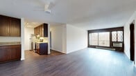 Located at 430 Mendota Rd W in West St. Paul, MN, this single-floor, three-bedroom, one-bathroom home offers a well-organized layout with a comfortable mix of living spaces. The open living and dining area is a highlight of the home, featuring durable hardwood-style flooring, a textured ceiling, and a ceiling fan. A large sliding glass door floods the space with natural light and provides direct access to a private balcony with outdoor views, complemented by classic diamond-pane accent windows. The galley-style kitchen is efficiently designed with rich dark wood cabinetry, granite countertops, stainless steel appliances including a refrigerator, electric range, dishwasher, and built-in microwave, all set over matching hardwood-style flooring. The primary bedroom is a generously sized retreat with hardwood-style flooring and a ceiling fan, while the two additional bedrooms feature neutral carpet and clean white walls. A dedicated walk-in closet offers ample storage with built-in shelving and hanging rods. The full bathroom is neatly finished with mosaic tile flooring and a tub/shower combo. A hallway connects all rooms, completing this functional and well-appointed home.