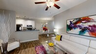 Located at 1994 Bent Creek Way SW in Atlanta, GA, this well-appointed 2-bedroom, 2-bathroom single-floor home offers a thoughtfully designed layout with modern finishes throughout. The open-concept kitchen and living area serves as the heart of the home, featuring a center island with dark granite countertops, white cabinetry, black appliances, and track lighting overhead. Wood-style flooring flows throughout the main living areas, adding warmth and visual continuity. The living room is bright and welcoming, highlighted by vaulted ceilings, a ceiling fan, large windows with access to an outdoor area, and ample room for comfortable seating. Both bathrooms are finished with white vanity cabinetry, dark granite countertops, wide mirrors, and wood-style flooring. The spacious primary bedroom features plush carpeting, a large window that invites natural light, and a dedicated walk-in closet with dual hanging rods and shelving. A second well-sized bedroom also includes carpeted flooring and generous closet access. A dedicated laundry area with a full-size washer and dryer adds everyday convenience. Neutral gray tones throughout create a clean, contemporary ambiance suitable for a variety of interior styles.