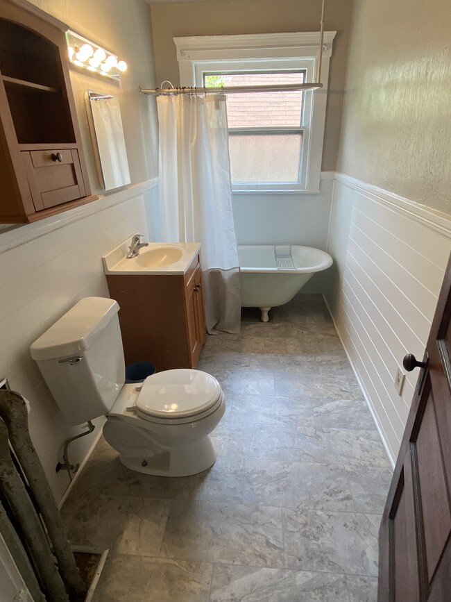 Updated bathroom with original clawfoot tub - 1210 Clark Ave