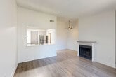 Located at 16832 E Wyoming Cir in Aurora, CO, this efficiently designed single-floor residence makes excellent use of its compact footprint. The open-concept living and dining area serves as the heart of the home, featuring light wood-style flooring, a textured ceiling, a ceiling fan, and a classic fireplace with a painted mantel. A pass-through window connects this space to the kitchen, promoting an open and airy feel while maintaining functional separation. Sliding glass doors with vertical blinds lead to an outdoor area, filling the living space with natural light.

The kitchen is well-appointed with gray shaker-style cabinetry, sparkling quartz countertops, stainless steel appliances including a refrigerator, electric range, and dishwasher, and light wood-style flooring. The space is practical and modern in its finish.

The bedrooms feature plush carpeting and sliding glass door access to outdoor spaces, with vertical blinds providing privacy and light control. The bathrooms echo the home's updated aesthetic, showcasing gray vanities with quartz countertops and a tub/shower combo. Additional conveniences include a dedicated laundry area, utility room, hallway, and two closets, rounding out a thoughtfully organized layout.