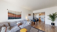 Located at 1003 N 32nd St in Phoenix, AZ, this one-bedroom, one-bathroom unit offers a well-organized single-floor layout with a practical mix of living, working, and sleeping spaces. The open-concept living area flows seamlessly into the kitchen and dining space, featuring hardwood-style flooring throughout and a textured ceiling. A front-facing window in the living room brings in natural light, complementing the bright, neutral walls that create a clean and welcoming atmosphere. The kitchen is equipped with warm wood cabinetry, dark granite-style countertops, a full-size refrigerator, electric range, and an under-cabinet range hood — offering everything needed for everyday cooking. The dedicated office space provides a functional area separate from the main living quarters. The bedroom is a comfortable, well-proportioned retreat with a window for natural light and access to a closet for storage. The full bathroom features a tub-shower combination, wood-toned vanity with dark countertop, and tile-style flooring. A hallway connects the rooms, providing a logical and efficient flow throughout the space. Overall, the unit presents a practical and cozy living environment well-suited for single occupancy in the heart of Phoenix.