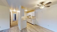 Located at 2487 Chestnut Hills Dr in Kalamazoo, Michigan, this single-floor, two-bedroom, one-bathroom unit offers a well-organized and efficiently designed layout. The kitchen is a standout feature, showcasing white shaker-style cabinetry, quartz-style countertops with brushed nickel hardware, a single-basin sink, and light luxury vinyl plank flooring that extends throughout the main living areas. A ceiling fan with integrated lighting adds both comfort and function to the open area adjacent to the kitchen, which also includes built-in open shelving for additional storage.

The primary bedroom is generously sized, featuring plush carpet, a ceiling fan, a window that brings in natural light with views of the surrounding neighborhood, and dual dark wood sliding closet doors. The second bedroom offers a similarly clean, carpeted space with its own door access and bright white walls.

The bathroom is neatly appointed with white cabinetry, quartz-style countertops, brushed nickel fixtures, and a full tub/shower combination set against clean white surroundings, with light wood-tone LVP flooring tying the space together. Throughout the unit, the consistent use of neutral tones, updated finishes, and ceiling fans creates a cohesive, move-in-ready atmosphere.