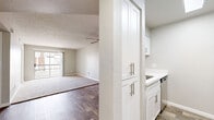 Located in Phoenix, AZ, this 2-bedroom, 1-bathroom residence offers a well-organized single-floor layout designed for comfortable everyday living. The open living area features wood-look flooring, a ceiling fan, and a sliding glass door that fills the space with natural light and provides access to an outdoor patio. The galley-style kitchen is outfitted with white shaker cabinetry featuring brushed nickel hardware, white quartz countertops, a stainless steel appliance suite including a refrigerator, range, microwave, and dishwasher, and wood-look tile flooring that carries through from the living area. Both bedrooms are carpeted and finished with neutral toned walls, white baseboards, and window blinds that allow for adjustable natural light. The primary bedroom benefits from two windows, enhancing its bright and airy feel. The full bathroom includes a white quartz vanity with an integrated sink, a mirror with overhead lighting, wood-look tile flooring, and a tub-shower combination. A hallway and closet provide additional storage and connectivity throughout the home. Textured ceilings are present throughout the residence, adding a consistent architectural finish to every room.