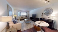 Located at 34 S Lexington Ave in White Plains, NY, this well-appointed single-floor residence offers a comfortable and functional layout ideal for everyday living. The open-concept living and dining area serves as the heart of the home, featuring rich hardwood flooring, a textured ceiling, and a corner window arrangement that invites natural light throughout the space. The living area provides generous room for seating and entertainment, flowing seamlessly into a dedicated dining space.

The kitchen is efficiently designed with granite countertops, dark cabinetry, stainless steel appliances including a gas range, microwave, and refrigerator, and light tile flooring. A breakfast bar connects the kitchen to the main living area, enhancing the open feel.

The primary bedroom is carpeted and comfortably sized, offering a large window for natural light, a closet, and direct access to a private en-suite bathroom. The en-suite features a double-sink vanity with granite countertops, white cabinetry, and polished tile flooring. A second full bathroom includes a tub-shower combination with glass sliding doors and a granite-topped vanity. An additional bedroom provides ample space with its own closet and neutral carpeting, suitable for use as a guest room or home office.