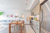 Located at 205 Queen St E in Brampton, Ontario, this thoughtfully designed 3-bedroom, 2-bathroom unit offers a bright, modern aesthetic throughout its single floor. The open-concept layout seamlessly connects the kitchen, dining area, and living room, creating an efficient yet welcoming common space. The contemporary kitchen is outfitted with light wood cabinetry extending to the ceiling, stainless steel appliances including a full-size refrigerator, range, and dishwasher, complemented by track lighting overhead and a clean subway tile backsplash. The living room is anchored by large floor-to-ceiling sliding glass doors that lead to a private balcony, flooding the space with natural light and offering sweeping views of the surrounding Brampton cityscape. Light hardwood-style flooring runs throughout, enhancing the airy, cohesive feel. Each bedroom features sliding closet doors and windows with roller blinds. The primary bedroom enjoys elevated outdoor views. Two well-appointed bathrooms include textured tile surround walls — one featuring a soaker tub and the other a glass-enclosed walk-in shower. A dedicated entryway closet and a connecting hallway complete this efficiently organized and stylishly finished home.