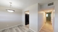 This single-floor residence offers a clean, functional layout with a variety of updated finishes throughout. The living and dining areas feature light gray wood-look luxury vinyl plank flooring, neutral-toned walls, and textured ceilings, creating a cohesive and contemporary feel. The dining area is highlighted by a pendant light fixture and a window that allows natural light to fill the space.

The kitchen is well-equipped with crisp white cabinetry, granite-style countertops, black appliances including a full-size refrigerator and an electric range, and a ventilation hood above the stove. Light-toned LVP flooring continues seamlessly throughout the kitchen, complementing the overall design.

The bedrooms are carpeted for added comfort and feature neutral wall tones, textured ceilings, and windows with blinds that bring in natural light. Each room offers a generous sense of space and includes ample wall area for flexible furniture arrangements.

The bathroom is outfitted with a tub-shower combination, a toilet, and a vanity with a white sink, all set on wood-look vinyl flooring. A closet adjacent to the bathroom adds convenient storage.

Throughout the residence, white panel doors and clean white baseboards provide a polished, move-in-ready appearance. The layout flows naturally from room to room, making it a practical and comfortable living space.