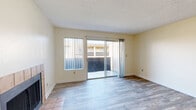 This well-designed 660 square foot apartment in Spring Valley, California, offers a blend of comfort and functionality. The single-story layout comprises one bedroom, one bathroom, and an open-concept living area. The spacious primary bedroom, measuring 220 square feet, provides ample space and includes a built-in closet for storage.

The heart of the home features a combined kitchen and living room, showcasing modern finishes and appliances. The kitchen boasts white cabinetry, a full suite of white appliances, and a practical galley layout with a skylight that bathes the space in natural light. The living area is anchored by a tile-framed fireplace, adding warmth and character to the space.

Throughout the apartment, you'll find a mix of flooring types, including plush carpeting in the bedroom and durable wood-look flooring in the main living areas. Large windows and sliding glass doors allow plenty of natural light to flood the space, creating a bright and airy atmosphere.

The bathroom offers modern fixtures, including a shower-tub combination with a sliding glass door, ensuring both practicality and style. The apartment's neutral color palette provides a blank canvas for personalization, while the textured ceiling adds a subtle architectural detail throughout.

With its efficient use of space and modern amenities, this Spring Valley apartment presents an ideal living solution for those seeking a comfortable, low-maintenance home in a convenient location.