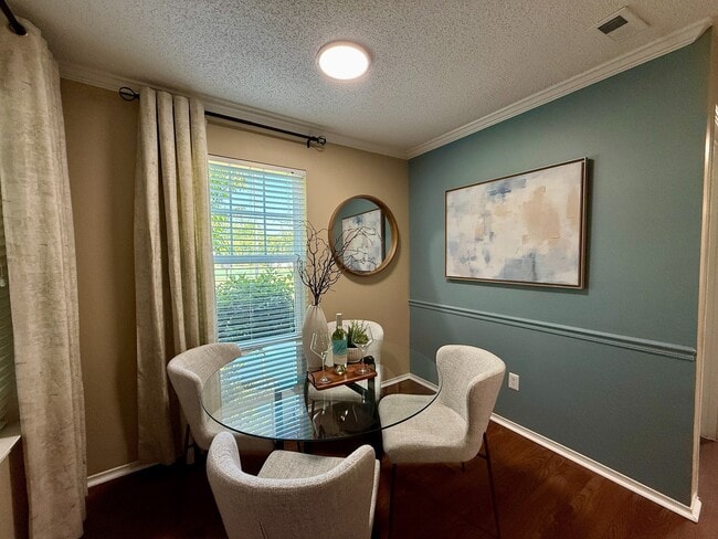 Dining area with hardwood-style flooring & overhead lighting - Vetra at Hamilton Place