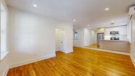 Located at 169 Union Street in Poughkeepsie, NY, this thoughtfully renovated single-floor unit offers three bedrooms and two bathrooms across a well-organized layout. Warm-toned hardwood floors run throughout, lending a cohesive and inviting feel to every room. The open-concept living and kitchen area forms the heart of the home, bathed in natural light from multiple windows. The modern kitchen is outfitted with stainless steel appliances, sleek light wood cabinetry, a white quartz waterfall island with an undermount sink, and pendant lighting — a functional yet stylish space for cooking and entertaining. Each bedroom is bright and well-proportioned, featuring wall-mounted mini-split units for individual climate control. The spacious primary bedroom includes its own closet access. The bathrooms are elegantly finished, with one showcasing large-format marble-style tile in a frameless glass shower enclosure and decorative floor tilework. Recessed lighting illuminates the common areas, while the bedrooms feature both recessed and ceiling-mounted fixtures. With four closets and a dedicated laundry room, storage and convenience are well-addressed throughout this clean, move-in-ready home.