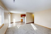 Located at 1200 Meadowview Dr in Marion, Iowa, this two-bedroom, one-bathroom single-floor unit offers a practical and comfortable layout. The open living area features neutral beige walls, plush carpet flooring, and natural light streaming through windows, creating a bright and welcoming atmosphere. The transition from carpet to hard surface flooring marks the entry into the kitchen, which is equipped with warm oak cabinetry, ample counter space in an L-shaped configuration, a double-basin sink, and white appliances including an electric range and refrigerator, all set atop wood-look vinyl flooring.

Both bedrooms are carpeted and feature wood-trimmed windows that allow in natural light. The primary bedroom is generously sized, offering dual windows and room for a full furniture arrangement. The second bedroom includes a sliding wood-panel closet, providing practical storage. A hallway connects the bedrooms to the full bathroom, which features a single-sink vanity with oak cabinetry, a large mirror with overhead lighting, a bathtub with shower, and a window for ventilation. A dedicated utility room completes the layout, adding functional storage space to this well-organized home.
