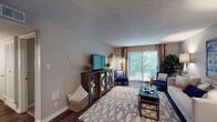 This single-story residence at 226 Breckinridge Square in Louisville, Kentucky, offers a thoughtfully designed layout with a cohesive neutral color palette and wood-style flooring running through the main living areas. The living room serves as the centerpiece of the home, featuring a textured ceiling, a large sliding glass door that floods the space with natural light and provides views of lush outdoor greenery, and ample room for comfortable furnishings.

The kitchen is well-equipped and stylishly updated, showcasing gray shaker-style cabinetry, light stone-look countertops, a white subway tile backsplash, and black appliances including a range, built-in microwave, refrigerator, and dishwasher. A double-basin sink with a brushed nickel faucet completes the functional workspace, with an opening connecting the kitchen to the adjacent dining area.

The bedroom is a calm retreat with plush wall-to-wall carpeting, neutral gray walls, a textured ceiling, and a window that brings in natural light. A mirrored closet provides practical storage. The bathroom features a vanity with gray cabinetry, consistent with the home's overall design language, and dark wood-style flooring. Throughout the residence, attention to detail and updated finishes create a comfortable and contemporary living environment.