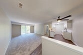 Located at Timberidge Circle in Farmington Hills, Michigan, this one-bedroom, one-bathroom residence offers a well-organized single-level layout designed for comfortable everyday living. The combined kitchen and living room area forms the heart of the home, with the kitchen showcasing white shaker cabinetry with black hardware, marble-look countertops, white appliances including a range and refrigerator, and wood-look flooring that adds warmth to the space. The living room is carpeted and filled with natural light, featuring a sliding glass door that opens onto a private balcony overlooking a lush, tree-lined landscape — a serene outdoor retreat. The spacious bedroom offers generous proportions, soft carpeting, a large window with vertical blinds, and a double-door closet providing ample storage. Neutral tones throughout the home create a clean, cohesive aesthetic. The bathroom is outfitted with a full tub and shower combo featuring matte black fixtures, lending a contemporary touch. Two hallways connect the spaces efficiently, contributing to a smooth and practical flow. The overall ambiance is calm and move-in ready, with thoughtful finishes and a natural backdrop that sets this Farmington Hills residence apart.