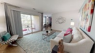 Located at 10337 Society Park Drive in Cockeysville, Maryland, this single-floor residence offers a thoughtfully designed layout that balances comfort and functionality. The bright living room serves as the heart of the home, featuring hardwood-style flooring, a teal accent wall, and large sliding glass doors that flood the space with natural light and open directly onto a private balcony overlooking lush tree views. The living area flows seamlessly into a dedicated dining space, ideal for everyday meals or entertaining.

The kitchen is outfitted with dark cabinetry, granite-style countertops, a tile backsplash, stainless steel appliances, and light wood-tone flooring. A convenient in-unit laundry closet with a stacked washer and dryer is tucked just off the kitchen.

The primary bedroom is generously sized with plush carpeting, ample natural light, and access to a full bathroom featuring dual sinks set into granite countertops and dark wood vanity cabinetry with tile flooring. A second bedroom, also carpeted, offers a bright window with outdoor views and versatile space suitable for sleeping or a home office.

Throughout the residence, clean white walls, consistent finishes, and well-proportioned rooms create a welcoming and cohesive atmosphere.