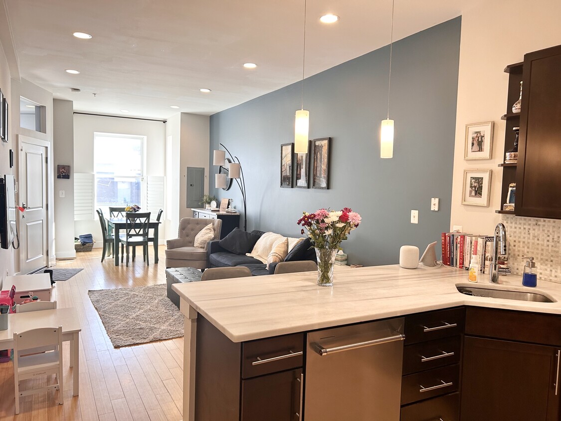 Open layout with a breakfast bar, living area, and light-filled dining nook - 1241 Kenyon St NW