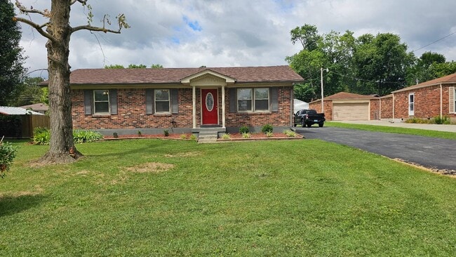 front view with yard and parking drive - 273 Circle Dr House