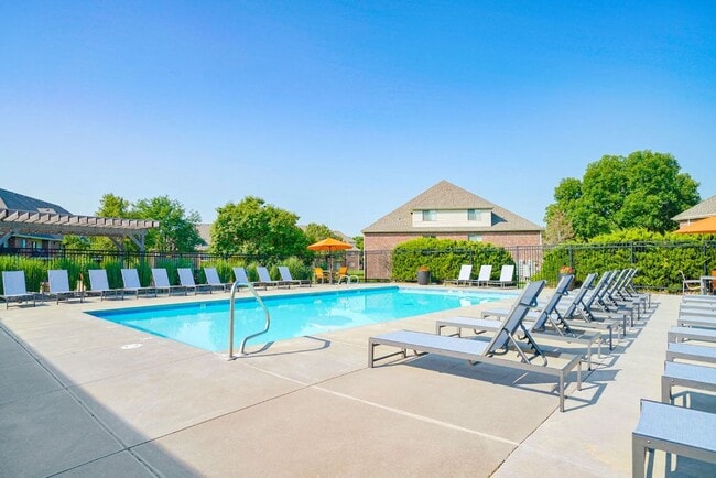 Sunny days are made for poolside fun! Lounge, play, or unwind in our inviting pool area. - Fountain Glen