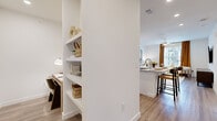 This 1-bedroom, 1-bathroom residence in Manor, Texas is designed with a clean, modern aesthetic and functional layout across a single floor. Light wood-style flooring flows throughout, providing a cohesive and contemporary feel.

The kitchen is a standout feature, equipped with white shaker cabinets, granite countertops, a tile backsplash, stainless steel appliances including a refrigerator with ice maker, range, microwave, and dishwasher. A peninsula with an undermount sink offers additional prep space and casual seating.

The living room is bright and welcoming, featuring a ceiling fan, large windows with views of the surrounding community, and ample space for relaxing or entertaining. Adjacent to the living area, a built-in open shelving unit with a dedicated desk nook provides a practical workspace.

The bedroom is a serene retreat, offering generous space, large windows with natural light, and direct access to the bathroom. The bathroom features white cabinetry, granite countertops, an undermount sink, and a clean, well-lit vanity with a large mirror. A walk-in closet with built-in shelving and hanging rods completes the private quarters, offering organized and efficient storage throughout this thoughtfully designed home.
