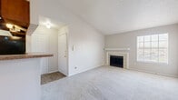Located at 4035 Towne Crossing Blvd in Mesquite, TX, this single-story, 2-bedroom, 1-bathroom home offers a well-organized layout with a welcoming entrance that opens into a spacious living area. The living room stands out with soaring vaulted ceilings that create a sense of openness, soft carpeting underfoot, and a tile-surround wood-burning fireplace serving as a focal point. A ceiling fan adds comfort and functionality to the space. The adjoining kitchen features warm wood cabinetry, a tiled backsplash in muted blue tones, granite-style countertops, a breakfast bar peninsula, and wood-look flooring — all opening directly to the living and dining area for a connected, open-concept feel. A pantry provides additional storage. The primary bedroom is a well-proportioned retreat with plush carpeting and a dedicated closet. The second bedroom is similarly carpeted with ample space and closet access. The shared full bathroom includes a tiled tub-shower combo with clean white tile surround. Throughout the home, neutral tones, textured ceilings, and consistent finishes contribute to a cohesive and functional living environment suited for everyday comfort.