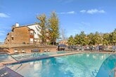 Located at 100 Hickory Highlands Dr in Antioch, TN, this 810-square-foot, single-floor apartment offers 3 bedrooms and 2 bathrooms across a well-organized layout. The living room is a standout space, featuring vaulted ceilings, a white-surround fireplace, and two large windows that allow generous natural light to fill the room. Neutral-toned carpet adds warmth throughout the living and bedroom areas. The kitchen is open and functional, equipped with dark espresso cabinetry, stainless steel appliances including a range and refrigerator, light stone-finish countertops, and wood-look tile flooring. A pass-through bar connects the kitchen to the living area, enhancing the open-concept flow. The primary bedroom measures 140 square feet and includes a walk-in closet outfitted with wire shelving. The secondary bedrooms each feature carpet flooring, ceiling fans or overhead lighting, and built-in closets. Both bathrooms include a tub-shower combination with white tile surrounds, wood-look tile flooring, and dark wood vanities. A dedicated hallway and additional closet space contribute to the unit's practical storage options. The overall aesthetic is clean and neutral, with consistent finishes throughout.
