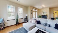 This well-appointed 2-bedroom, 2-bathroom residence in Brookfield, Wisconsin offers a thoughtfully designed single-floor layout that maximizes functionality and comfort. The open-concept kitchen is a standout feature, showcasing rich warm-toned cabinetry, granite countertops, stainless steel appliances, and a generous island with bar seating illuminated by industrial-style pendant lights — ideal for both cooking and casual dining. Light wood flooring flows throughout the kitchen and into the living room, which is anchored by a tiled fireplace, wall-mounted television, and multiple windows that invite natural light and outdoor views.

The primary bedroom is a comfortable retreat featuring large windows with scenic outdoor views, neutral tones, and soft carpeting. The second bedroom mirrors a similar design with its own window and closet access. Both bathrooms are finished with granite-topped vanities, warm wood cabinetry, and tile flooring, offering a clean and cohesive aesthetic.

A hallway connects the living areas to the private bedrooms, contributing to a practical and efficient floor plan. Throughout the residence, neutral wall tones, consistent finishes, and an abundance of natural light create a warm and inviting ambiance suitable for everyday living in the Brookfield community.