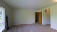 Located at 1552 Pine St in Columbus, Ohio, this single-floor property offers a clean and straightforward layout well-suited for comfortable everyday living. The interior features neutral, light-toned walls that create a bright and open atmosphere throughout. Carpeted flooring in a warm beige hue runs through the rooms, adding a layer of softness underfoot and contributing to the space's understated, livable feel. The ceiling is smooth and white, enhancing the sense of openness within the room. A classic wooden interior door with a traditional knob provides access between rooms, reflecting a practical and no-frills design sensibility. The overall ambiance is calm and unassuming, offering a blank canvas that can be easily personalized. The simple wall construction and neutral palette make the space adaptable to a variety of furnishing styles and uses. Electrical outlets are positioned conveniently along the baseboards. The property's single-floor design ensures easy accessibility and efficient use of space throughout. Situated in Columbus, OH, this property provides a modest and functional home base in a residential neighborhood setting.